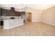 Spacious living room and kitchen with stainless steel appliances, island, and wood-look floors at 6097 Monterey Cypress Trl, Sanford, FL 32773