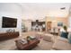 Bright, open-concept living room with tile floors, plush seating, and an adjacent modern kitchen at 6097 Monterey Cypress Trl, Sanford, FL 32773