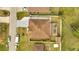 Overhead view of a single-story home featuring a brown roof, spacious yard, and concrete driveway at 639 Mesilla Dr, Kissimmee, FL 34758