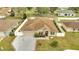 Expansive aerial view of a cozy home with a well-maintained yard and a fenced perimeter at 639 Mesilla Dr, Kissimmee, FL 34758