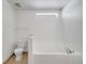 Bathroom featuring a soaking tub and tiled floor under a window for natural light at 639 Mesilla Dr, Kissimmee, FL 34758