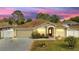 Charming single-story home with a well-manicured lawn and beautiful landscaping at 639 Mesilla Dr, Kissimmee, FL 34758
