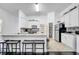 Bright kitchen with white cabinets, granite countertops, stainless steel appliances, and a pantry at 639 Mesilla Dr, Kissimmee, FL 34758
