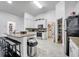 Open kitchen with island seating, stainless appliances, and tile floor at 639 Mesilla Dr, Kissimmee, FL 34758
