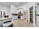 Well-lit kitchen with white cabinetry, granite countertops, and a pantry for ample storage at 639 Mesilla Dr, Kissimmee, FL 34758