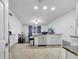Open kitchen with white cabinets, a central island, and stainless steel appliances at 639 Mesilla Dr, Kissimmee, FL 34758