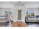 Open-concept room featuring dark wood floors and plenty of natural light at 639 Mesilla Dr, Kissimmee, FL 34758