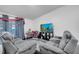 Cozy living room featuring plush seating, dark flooring and a large screen TV for entertainment at 639 Mesilla Dr, Kissimmee, FL 34758