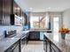 This is a full shot of the kitchen, highlighting the modern appliances and granite countertops, as well as the window views at 7345 Duxbury Ln, Winter Garden, FL 34787