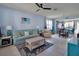 Comfortable living room featuring tile floors, ceiling fan, and a beach-themed decor at 7345 Duxbury Ln, Winter Garden, FL 34787