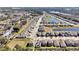 An aerial view of a neighborhood featuring many two-story homes and community ponds at 869 Rivers Crossing St, Clermont, FL 34714