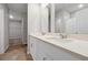 Bathroom with double sink vanity, framed mirrors, and a glass-enclosed shower at 869 Rivers Crossing St, Clermont, FL 34714