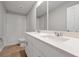 Bathroom featuring double sinks, white cabinets, and tiled shower and tub at 869 Rivers Crossing St, Clermont, FL 34714