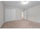 This cozy bedroom features neutral walls, carpeted floors, and a bright light fixture at 869 Rivers Crossing St, Clermont, FL 34714