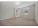 Neutral bedroom with carpet, light walls, and two windows providing natural light at 869 Rivers Crossing St, Clermont, FL 34714