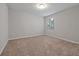 Bright bedroom featuring neutral walls, plush carpeting, and a window with natural light at 869 Rivers Crossing St, Clermont, FL 34714