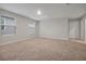 Bright bonus room with plush carpeting, neutral decor, and natural light streaming through the windows at 869 Rivers Crossing St, Clermont, FL 34714
