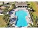 A bird's eye view of the community pool, featuring lounge chairs, palm trees and shade structures at 869 Rivers Crossing St, Clermont, FL 34714