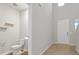 Bright entryway with white walls, tiled floor, and half bathroom at 869 Rivers Crossing St, Clermont, FL 34714