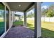 View of the patio with brick pavers and a spacious grassy backyard at 869 Rivers Crossing St, Clermont, FL 34714