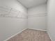 Empty walk-in closet with carpet and wire shelving, ready for your personal organization at 869 Rivers Crossing St, Clermont, FL 34714