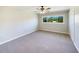 Bright bedroom features new carpet, a large window, and ample closet space at 915 Oak Ln, Lakeland, FL 33811