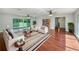 Bright living room featuring stylish furniture, hardwood floors, and sliding glass doors to the backyard at 915 Oak Ln, Lakeland, FL 33811