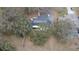 High angle aerial view of home featuring solar panels and lush green landscaping at 1102 Hamlin Ave, Howey In The Hills, FL 34737