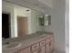 Bathroom featuring double sinks and large mirror at 1102 Hamlin Ave, Howey In The Hills, FL 34737