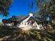 Charming home featuring brick accents, solar panels, and a spacious patio area perfect for outdoor entertaining at 1102 Hamlin Ave, Howey In The Hills, FL 34737
