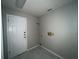 This laundry room has tile floors and a white door at 1102 Hamlin Ave, Howey In The Hills, FL 34737