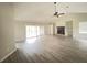 Open concept living room featuring vaulted ceilings, a brick fireplace, and sliding glass doors at 1102 Hamlin Ave, Howey In The Hills, FL 34737