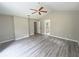 Spacious main bedroom with a ceiling fan, vaulted ceiling, and a view of the ensuite bathroom at 1102 Hamlin Ave, Howey In The Hills, FL 34737