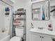 Functional bathroom with a shower, toilet, and vanity with sink, plus storage shelves at 11336 Bingham Ct, Orlando, FL 32837