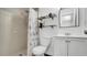 Bathroom featuring a shower and vanity with glass shelves above the toilet at 11336 Bingham Ct, Orlando, FL 32837