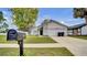 Traditional-style home with a well-manicured lawn and a two-car garage at 11336 Bingham Ct, Orlando, FL 32837