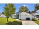Charming single-story home with a well-maintained lawn, mature trees, and a two-car garage at 11336 Bingham Ct, Orlando, FL 32837