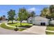 Attractive home featuring a green lawn, mature trees, and a paved driveway at 11336 Bingham Ct, Orlando, FL 32837
