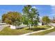 Property featuring a well-kept lawn, mature trees, and sidewalk at 11336 Bingham Ct, Orlando, FL 32837