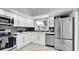 Bright kitchen featuring white cabinets, stainless steel appliances, and modern countertops at 11336 Bingham Ct, Orlando, FL 32837