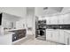Kitchen view of breakfast bar with stainless steel appliances, modern cabinetry, and tile floors at 11336 Bingham Ct, Orlando, FL 32837
