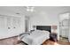 Well-lit main bedroom with wood floors, a ceiling fan, and an en-suite bathroom at 11336 Bingham Ct, Orlando, FL 32837