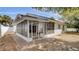 View of the home's screened porch with brick flooring and view to interior of the home at 11336 Bingham Ct, Orlando, FL 32837