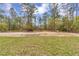 View of a grassy homesite, perfect for a new construction home, in a quiet wooded neighborhood at 12380 Sw 71St Lane Rd, Ocala, FL 34481