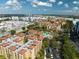 Expansive aerial view of a vibrant community featuring multiple pools and green spaces at 12527 Floridays Resort Dr # 401E, Orlando, FL 32821