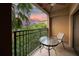 Relaxing balcony with seating and scenic views of lush greenery at sunset at 12527 Floridays Resort Dr # 401E, Orlando, FL 32821