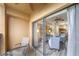 Inviting balcony area offering outdoor seating and serene views of the indoor living space at 12527 Floridays Resort Dr # 401E, Orlando, FL 32821