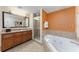 Luxurious bathroom featuring a soaking tub, walk-in shower, and dual sink vanity at 12527 Floridays Resort Dr # 401E, Orlando, FL 32821