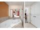 Elegant bathroom with a jetted tub and access to Primary bedroom, showcasing privacy at 12527 Floridays Resort Dr # 401E, Orlando, FL 32821