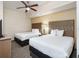 Spacious bedroom featuring two beds, contemporary decor, and a relaxing atmosphere at 12527 Floridays Resort Dr # 401E, Orlando, FL 32821
